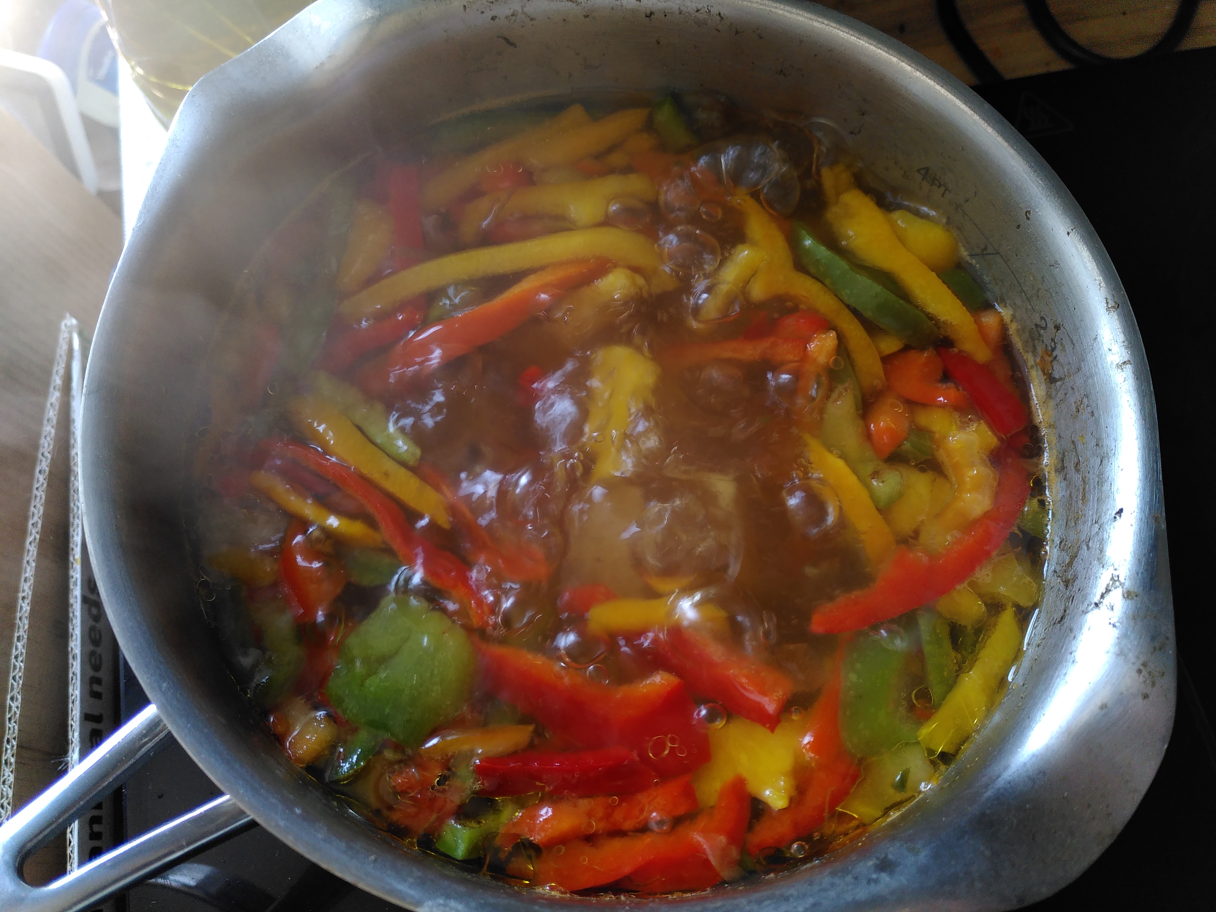 Saucepan with vegetables simmering to make a curry sauce