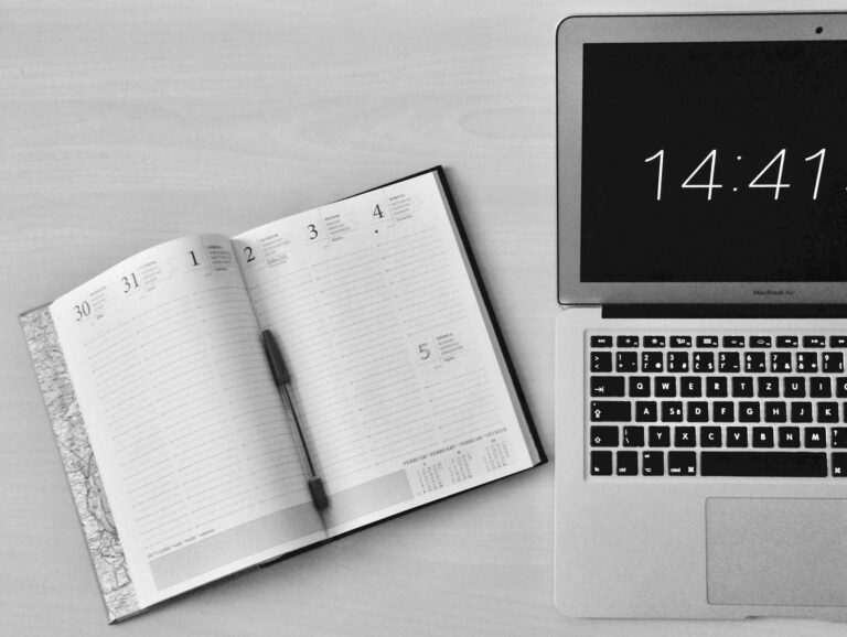 A laptop and calendar open on a desk. Chosen to depict the difficulty of achieving a good work-life balance alongside a portfolio career