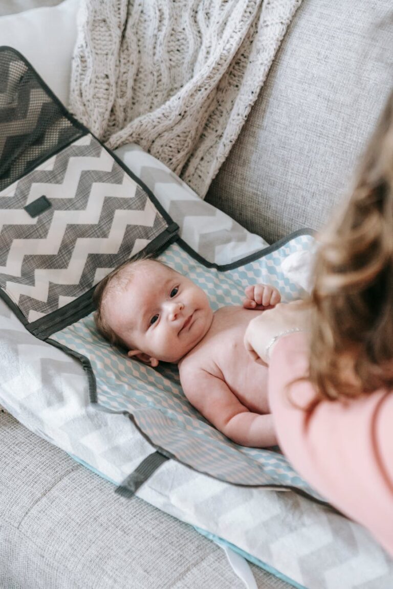 Baby on a changing mat having their happy changed.