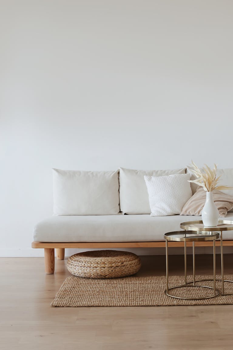 Minimal living room decor. White Couch on Wooden Floor