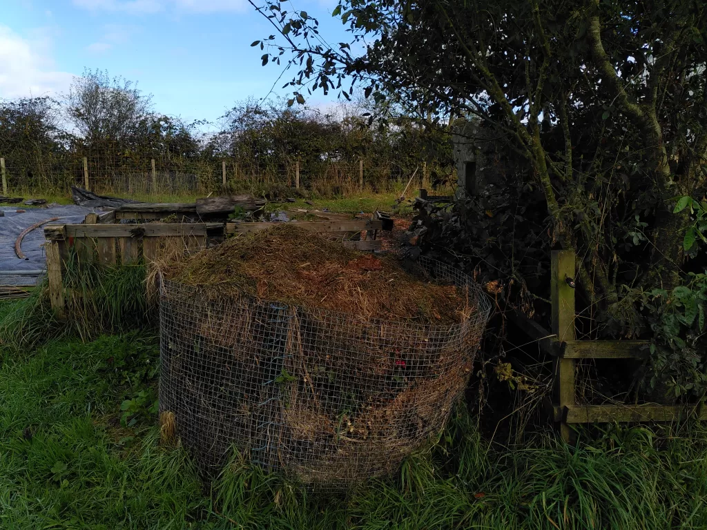 Image of two different compost heaps for making compost in a vegetable garden.