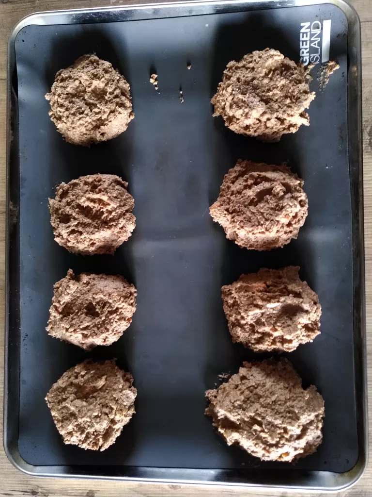 A baking tray containing nut burgers, ready to go in the oven.