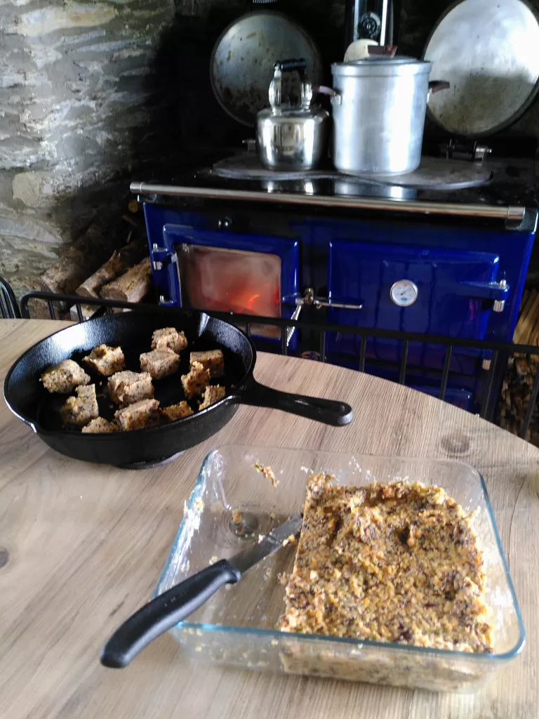 Red lentil tofu flavoured with seaweed flakes. One third of the tofu has been cut into chunks and placed in a cast iron skillet.