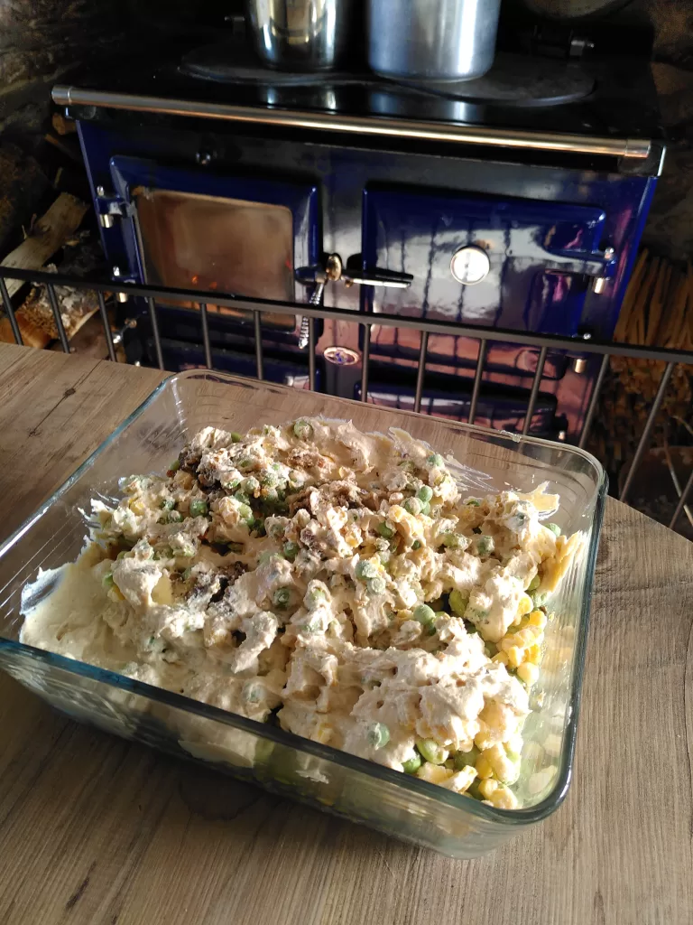 A rectangular glass Pyrex dish containing the filling for a vegan fishy pie.